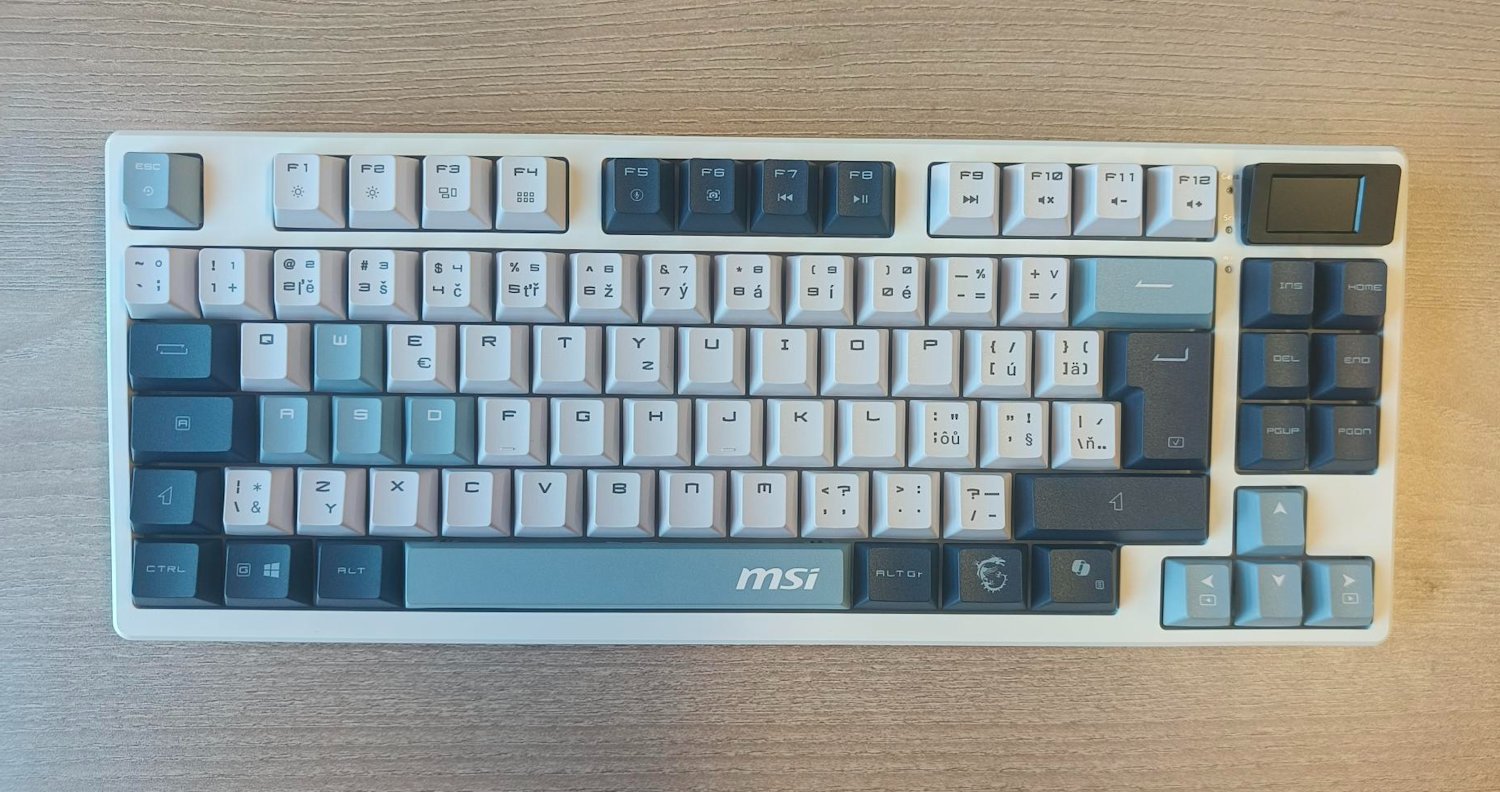 MSI herní klávesnice FORGE GK600 TKL Sky/ bezdrátová 2,4GHz+BT/ mechanická/ RGB/ USB-C/ display/ CZ+SK layout